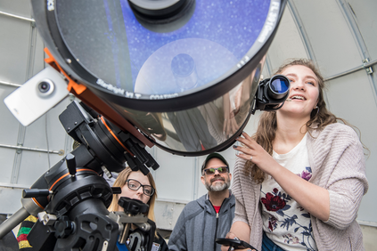 Student and professor with telescope